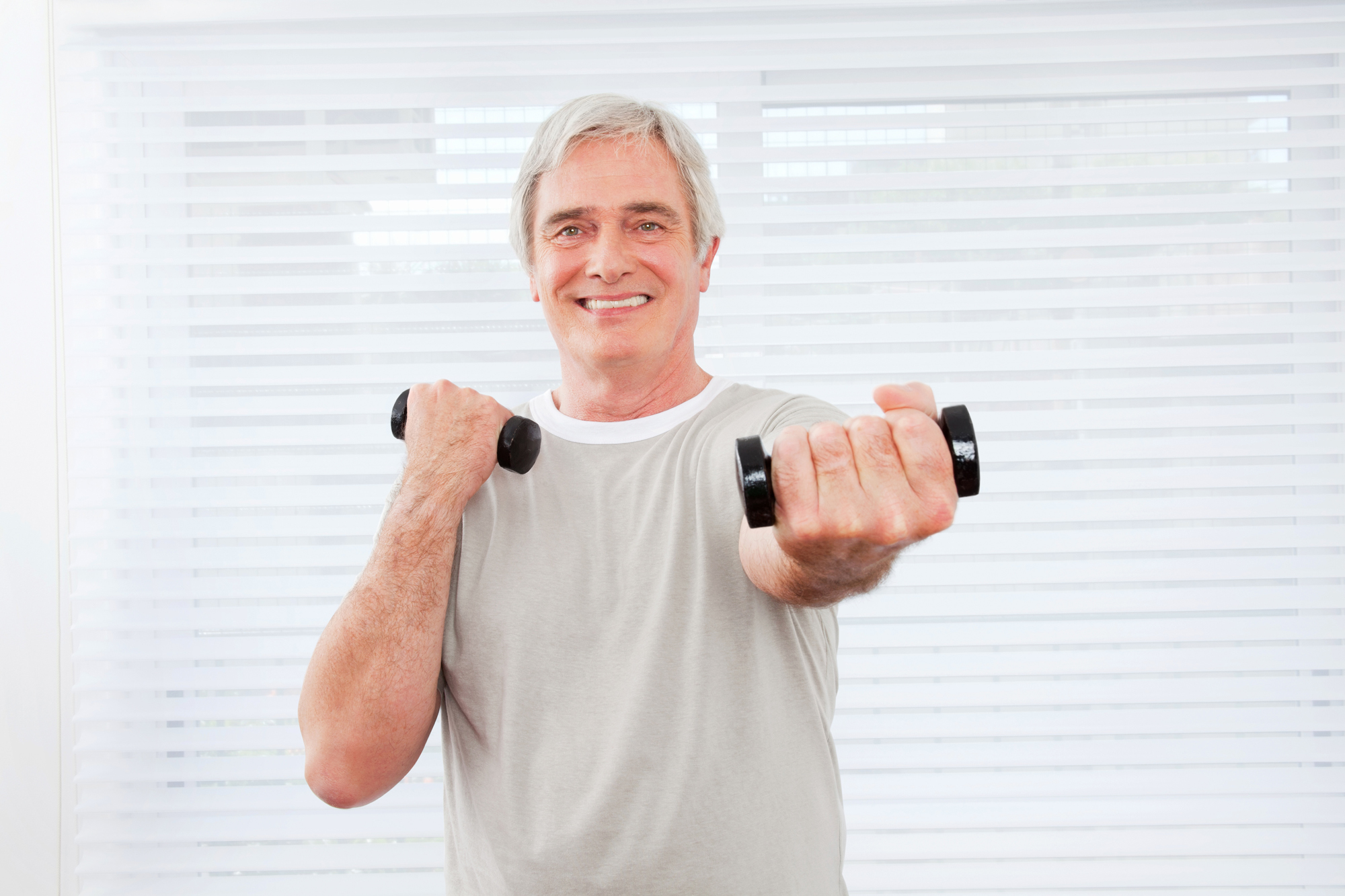 seniors holding a dumb bell